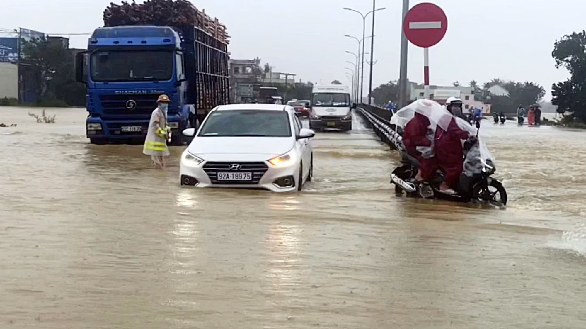 Nước lũ tràn qua QL1A, lực lượng CSGT làm “cọc tiêu sống” hướng dẫn giao thông -0