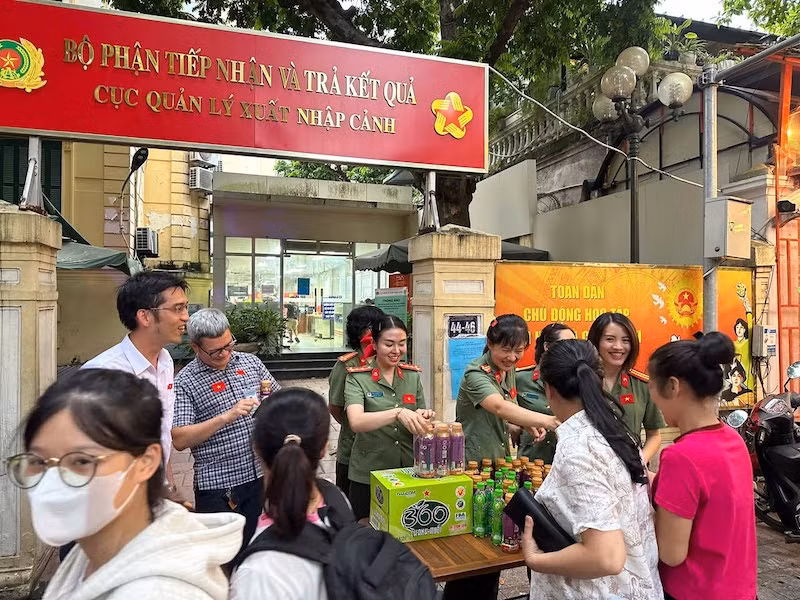 Cán bộ Cục Quản lý xuất nhập cảnh tặng nước phí, hỗ trợ người dân xem diễu binh, diễu hành -0