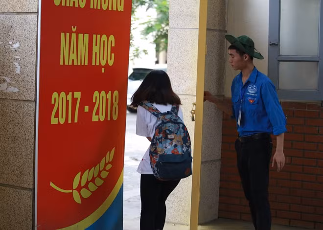Một thí sinh nữ vừa kịp chạy vào điểm thi tại điểm thi Trường THCS Việt Nam - Angieri trước giờ đóng cổng.