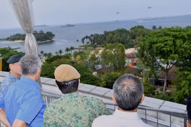Thủ tướng Singapore Lý Hiển Long cùng quan chức nhìn ra ngoài khơi từ Sentosa, nơi tàu và trực thăng quân sự Singapore đang tuần tra. Ảnh: BQP Singapore