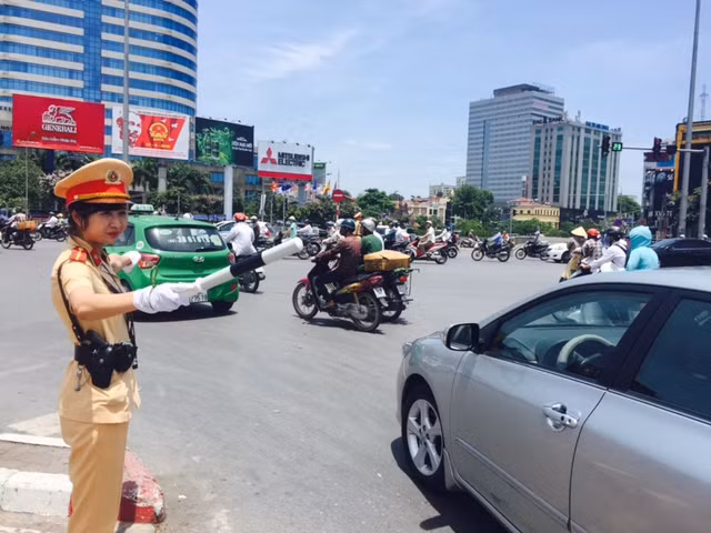 Một nữ CSGT đang "đội lửa" điều tiết giao thông.