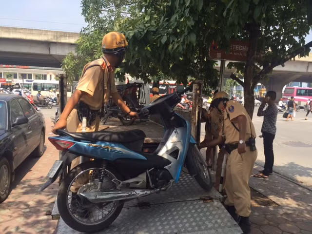 Cán bộ CSGT đội 6 đưa phương tiện bị tạm giữ về trụ sở