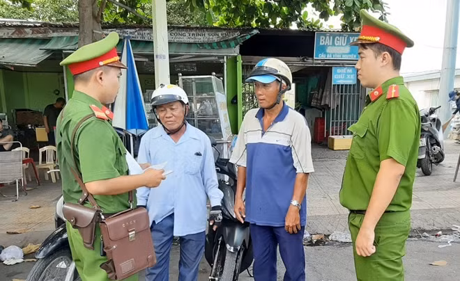 CBCS Công an phường Vĩnh Nguyên trao đổi thông tin với thành viên Đội xe thồ tự quản ANTT.