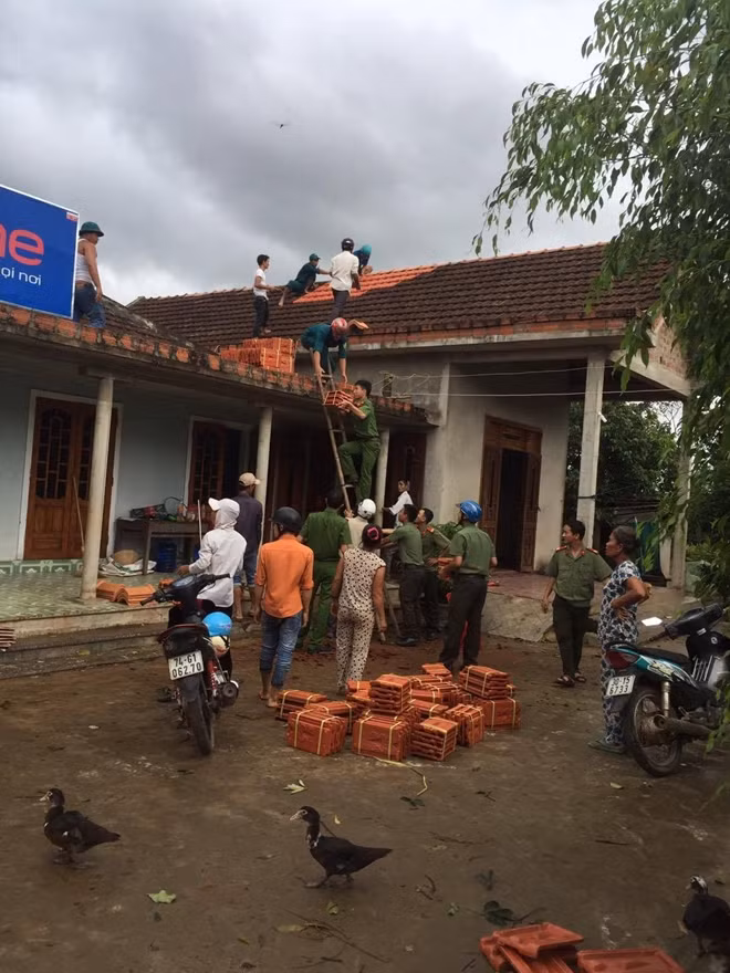 Công an Quảng Trị giúp dân lợp lại mái nhà do mưa lũ làm hư hỏng.