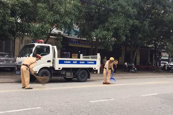 Hình ảnh các chiến sĩ CSGT Công an TP Hà Tĩnh quét đường giữa trưa ngày 13-11, lúc đã hết ca trực.