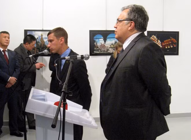 Đại sứ Nga tại Thổ Nhĩ Kỳ Andrei Karlov (ngoài cùng) phát biểu tại cuộc triển lãm trước khi bị ám sát.