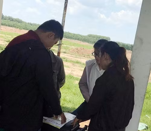 Nhân viên mặc áo in chữ Công ty Sài Gòn Land đang mời chào khách hàng ngay tại dự án.