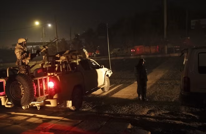 Lực lượng an ninh Afghanistan tiến về phía khách sản để tấn công nhóm nghi phạm. Ảnh: AFP