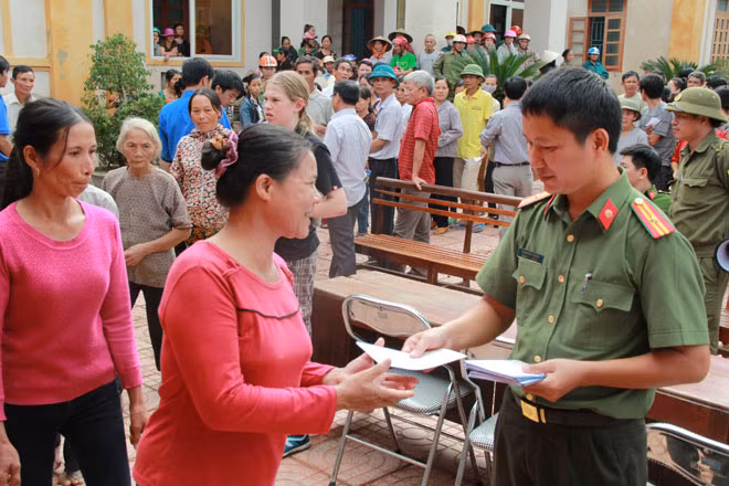 Thiếu tá Phan Đăng Trường, Trưởng ban Thời sự - Chính trị - Nghiệp vụ, Báo CAND trao quà tới bà con vùng lũ xã Hương Giang.