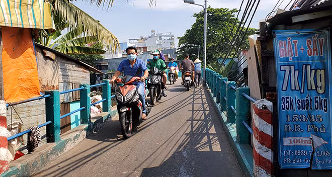 Những căn nhà tôn nằm ép sát cây cầu chỉ vừa đủ 2 xe máy tránh nhau. Những căn nhà tôn nằm ép sát cây cầu chỉ vừa đủ 2 xe máy tránh nhau.