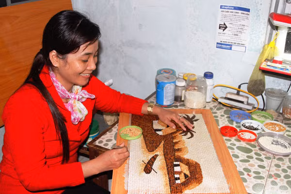 Chị Kiều đang chuyển tải hồn quê Việt vào tranh gạo.