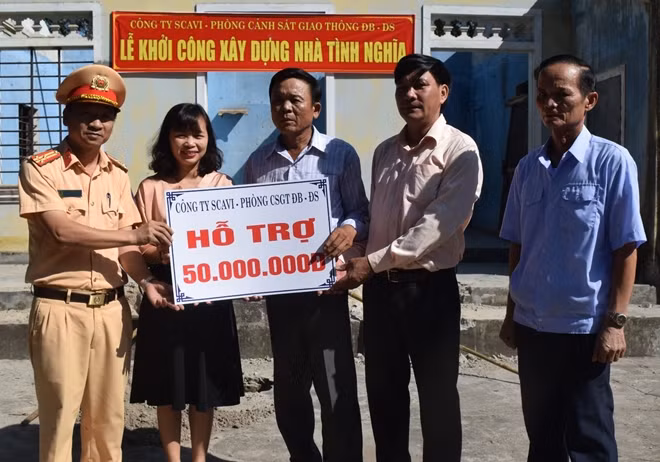 Đại diện lãnh đạo Phòng CSGT Công an tỉnh Thừa Thiên- Huế và Công ty Scavi Huế trao số tiền 50 triệu đồng hỗ trợ gia đình ông Vai xây nhà tình nghĩa.