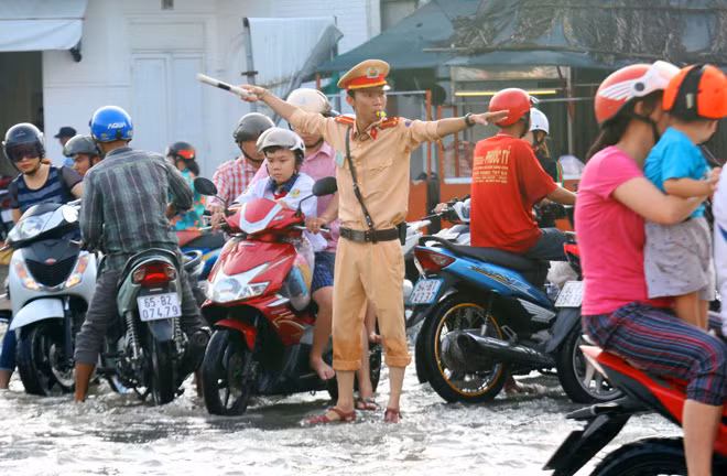 Cảnh sát giao thông phân luồng, điều tiết các phương tiện giữa "biển nước".