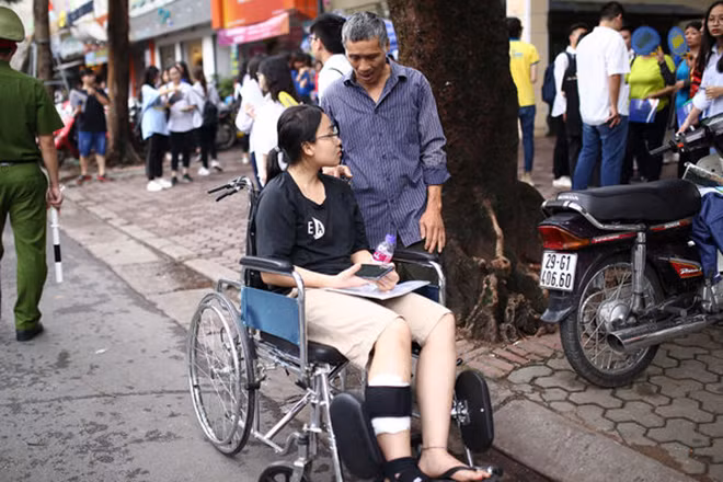 Nữ sinh phải đi xe lăn đến là em Nguyễn Thị Thuý Hà, học sinh trường Thực Nghiệm. Ông Nguyễn Minh Phong, bố của Hà cho biết, con gái bị tai nạn cách ngày thi một tuần. Gia đình khá lo lắng nhưng vẫn bình tĩnh, không tạo áp lực, chăm sóc để con thi cử tốt nhất.