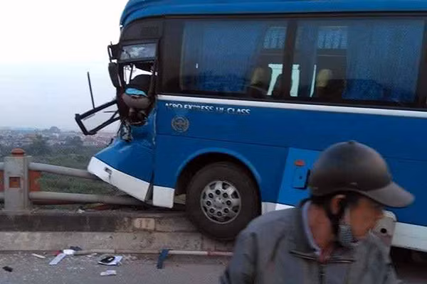 Xe khách nằm lơ lửng trên thành cầu.