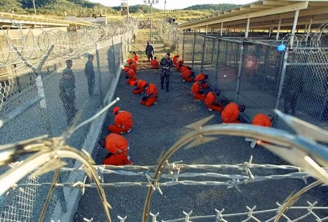 Lính canh Mỹ và các tù nhân ở nhà tù Guantánamo.