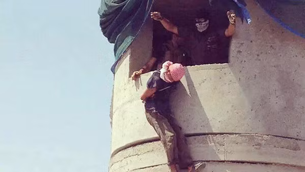 Một tù nhân bị dân quân Shiite Iraq thả rơi xuống đất hoặc treo xác trên một tháp canh. Ảnh: Instagram.