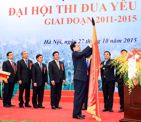 Thủ tướng Nguyễn Tấn Dũng gắn Huân chương Hồ Chí Minh lên cờ truyền thống của Ủy ban Biên giới Quốc gia (Bộ Ngoại giao). Ảnh: TTXVN.