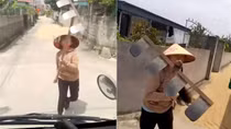 Dùng cào tấn công tài xế khi bị nhắc nhở phơi lúa trên đường