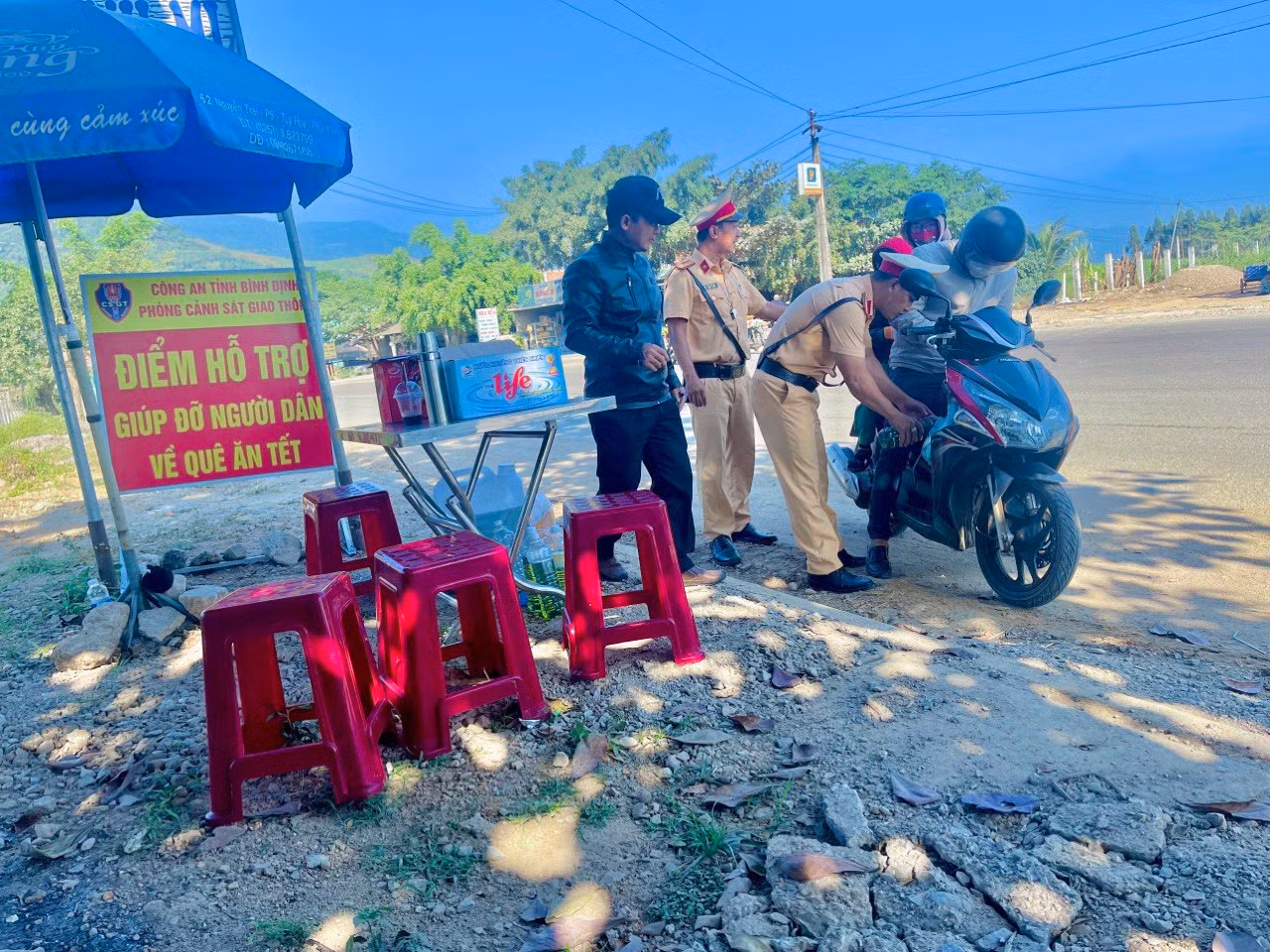 CSGT tặng mũ bảo hiểm, bánh chưng để tiếp sức cho người dân về quê ăn Tết -0