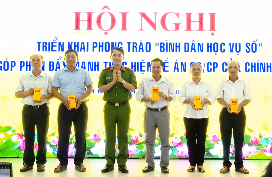 Đại diện lãnh đạo Phòng Cảnh sát Quản lý hành chính về TTXH trao điện thoại và sim cho bà con giáo dân.