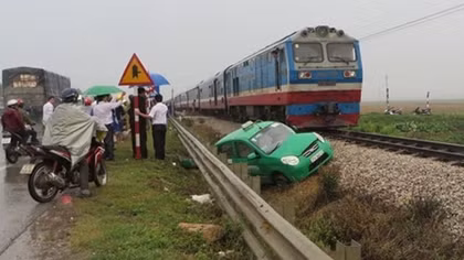Tàu hỏa kéo rê taxi Mai Linh 50m, 3 người đạp cửa xe thoát nạn