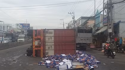 Xe container nổ bánh trước lật chắn ngang đường, hàng trăm thùng bia văng tung toé