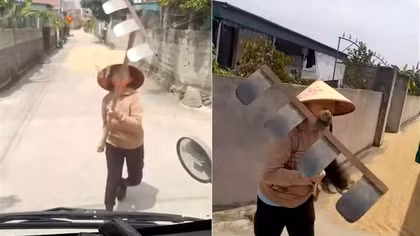Dùng cào tấn công tài xế khi bị nhắc nhở phơi lúa trên đường
