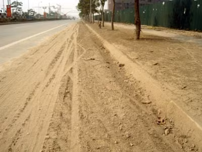 Cát rơi vãi trên mặt đường, vỉa hè, không người dọn.