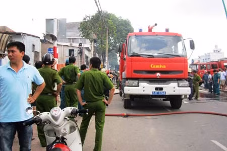 Cảnh sát PCCC nỗ lực để đám cháy không lan sang nhà bên cạnh.