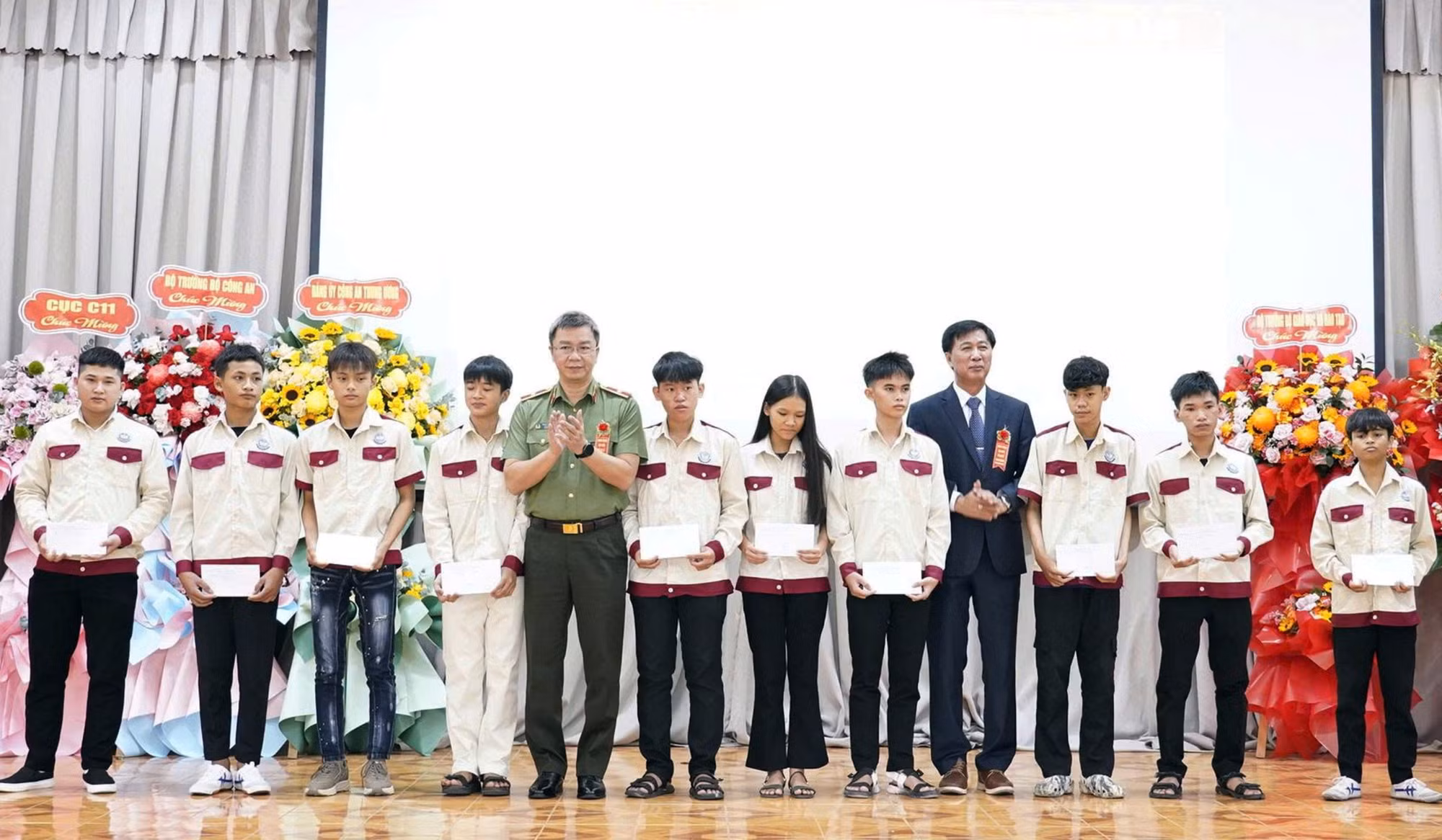 Thiếu tướng Phạm Kim Đĩnh và đại diện nhà trường trao 10 suất học bổng cho các HSSV có hoàn cảnh khó khăn.