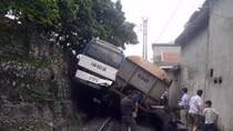 Tàu hỏa chèn xe khác chở công nhân "lơ lửng" trên sườn đồi