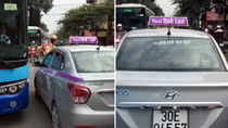 Cảnh sát giao thông bị taxi đẩy trên phố Minh Khai
