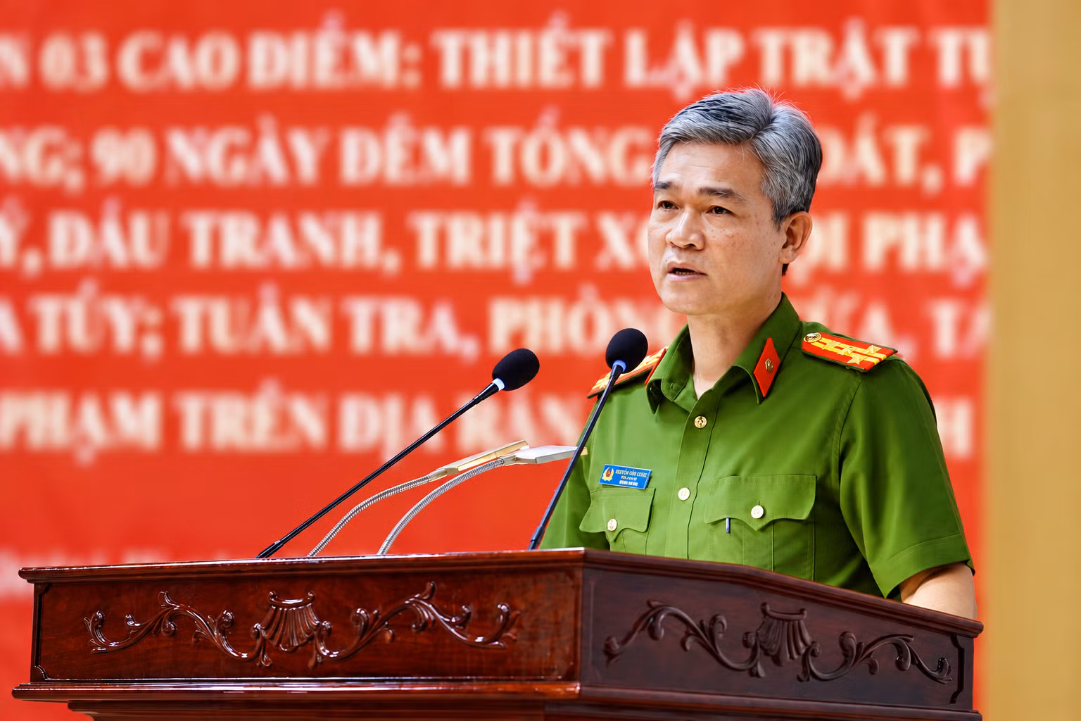 vietnamese-official-speaking-at-podium.png