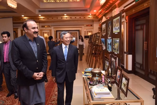 Ông Tariq Fazal Chaudhry (trái), quốc vụ khanh phụ trách quản lý và phát triển thủ đô của Pakistan, cùng Đại sứ Nguyễn Xuân Lưu xem tranh trong lễ kỷ niệm 72 năm ngày quốc khánh Việt Nam. Buổi lễ diễn ra tại một khách sạn ở Islamabad tối 29-8. Ảnh: TG&VN