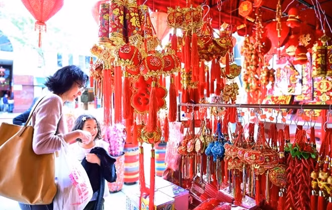 Lễ đón Tết cổ truyền theo lịch Mặt Trăng hiện đang được duy trì như một nét đẹp văn hoá tại Việt Nam và nhiều quốc gia và khu vực trên thế giới như Trung Quốc, Đài Loan (Trung Quốc), Hongkong, CHDCND Triều Tiên, Hàn Quốc... Trong ảnh là 2 mẹ con háo hức mua sắm đồ vật cho ngày lễ năm mới tại phố người Hoa ở bang California, Mỹ.
