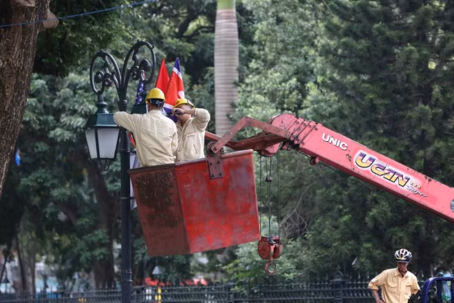 Công tác chuẩn bị cho sự kiện lớn này được triển khai tỉ mỉ trên từng con phố, xung quanh khu vực hồ Hoàn Kiếm (quận Hoàn Kiếm, Hà Nội). Các công nhân đang tiếp tục trang trí cột đèn cũng như lau dọn từng bóng đèn đường.