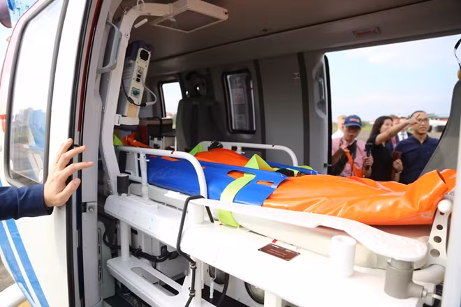 Bên trong khoang trực thăng Ansat với cáng và thiết bị y tế bên phải, cùng ghế ngồi cho y bác sĩ bên trái.