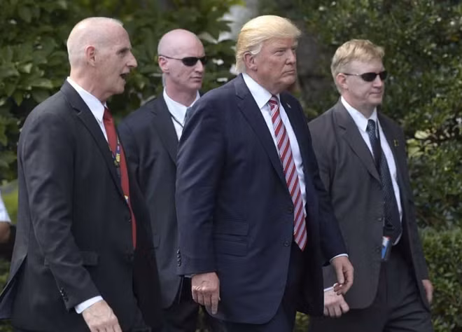 Các đặc vụ vây quanh Tổng thống Trump. Ảnh: Reuters
