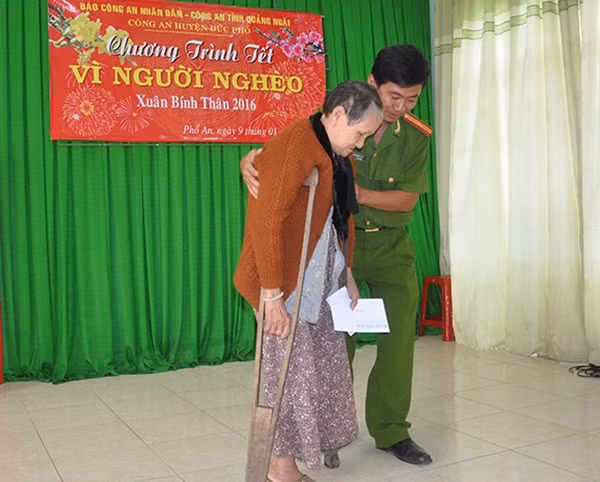 Một cụ bà nhận quà “Tết vì người nghèo” trong niềm phấn khởi.