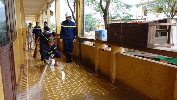 Gần 100 cán bộ, chiến sĩ PCCC Quảng Ngãi cùng phương tiện chuyên dụng đến Trường Tiểu học Hành Tín Đông, xã Hành Tín Đông, huyện Nghĩa Hành giúp thầy cô giáo ở đây dọn bùn non đọng trên sân, nền và bàn ghế để cho các em học sinh có nơi học tập trở lại.
