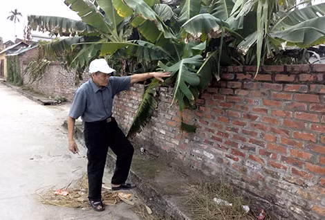 "Ông Thấn đang áng chừng diện tích chiều sâu của đất mà ông đã hiến để làm đường".