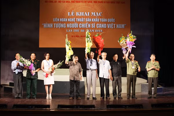 Trung tướng Trần Bá Thiều, Tổng cục trưởng Tổng cục Chính trị CAND và NSND Lê Tiến Thọ tặng hoa chúc mừng Ban giám khảo. Ảnh: Thiện Hoàng.