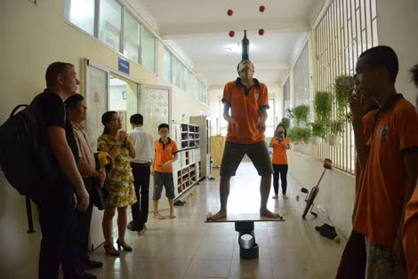Khôi Nguyên biểu diễn xiếc đi trên con lăn đội chai tung bóng.
