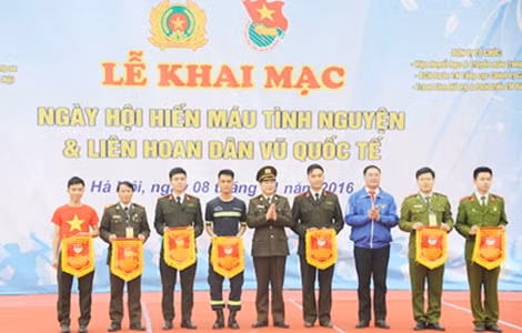 Trung tướng Nguyễn Xuân Mười, Phó Tổng cục trưởng Tổng cục Chính trị CAND trao cờ lưu niệm cho các đơn vị tham gia Liên hoan dân vũ.