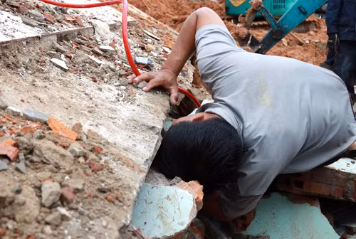 Người chồng xông vào hiện trường tìm kiếm vợ con. Ảnh: Xuân Ngọc.