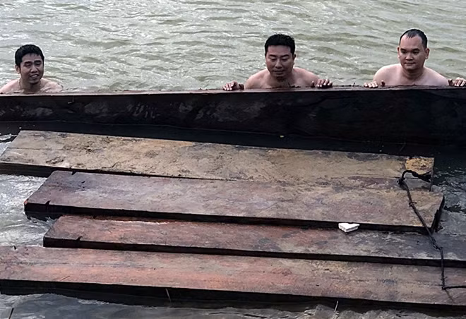 Lực lượng chức năng tiến hành trục vớt gỗ lậu.