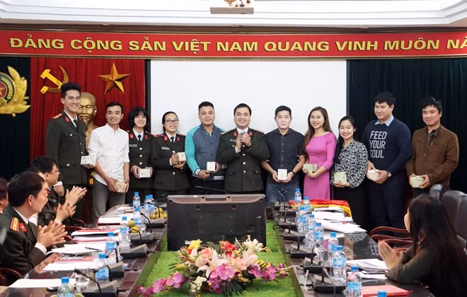 Thượng úy Trần Quang Huy, Bí thư Đoàn Thanh niên Báo CAND trao quà tặng động viên các đoàn viên được công nhận danh hiệu đoàn viên ưu tú năm 2017.