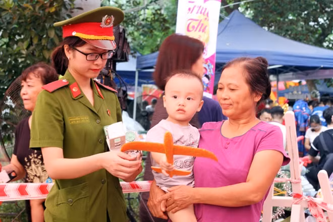 Người dân vui vẻ đón nhận những món quà Trung Thu từ tay các cán bộ, chiến sĩ.