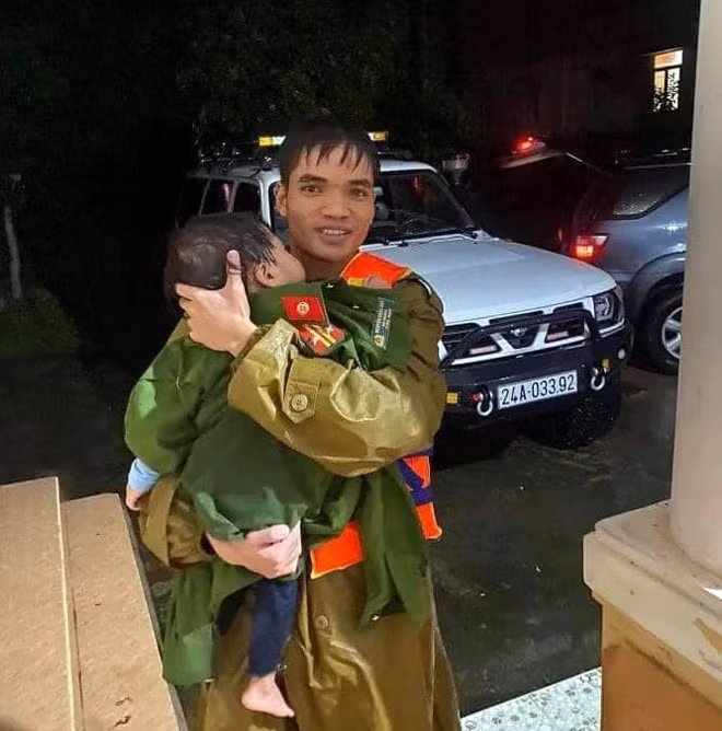 Ngay sau khi giải cứu 18 nạn nhân ra khỏi dòng nước lũ, chiến sỹ Công an cởi quân phục để cuốn vào cháu bé 2 tuổi để ủ ấm.